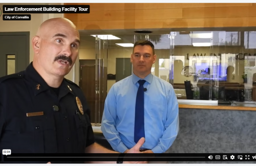 Video screenshot showing uniformed police chief speaking to the camera while standing in a public lobby