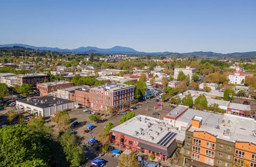 Downtown Corvallis Downtown Corvallis skyline with buildings and trees against a brilliant blue sky.