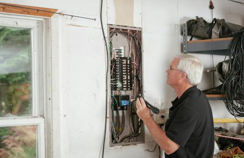 Man looking at electrical panel