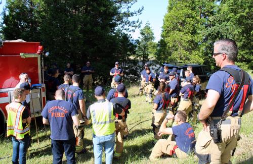 Corvallis Firefighters meeting outdoors before a training exercise.