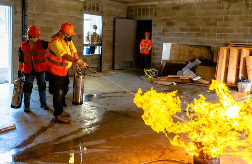 Volunteers dousing a blazing fire with water