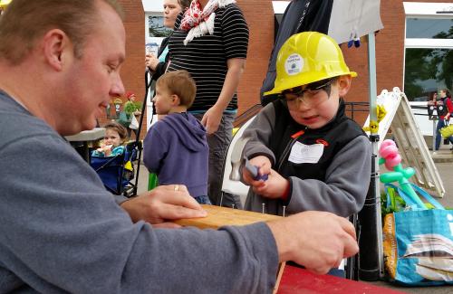 Building inspectors building birdhouses with kids