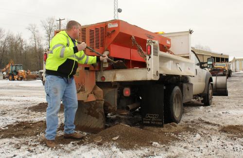 Public Works dump truck loading sand for snow and ice