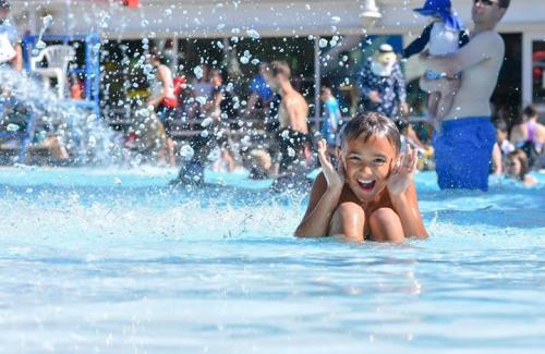 girl playing in otter beach outdoor pools