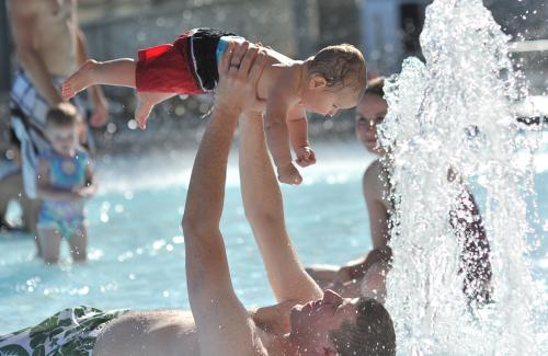 dad and son playing in otter beach pool