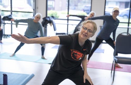 woman in fitness class stretching