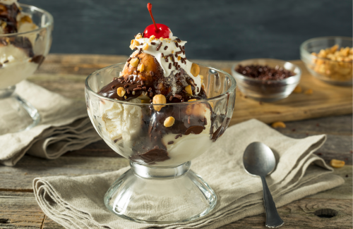 ice cream sundae with toppings in background