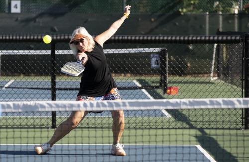 woman playing pickleball photo by amanda loman