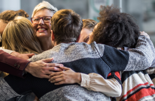 group hug of diverse individuals