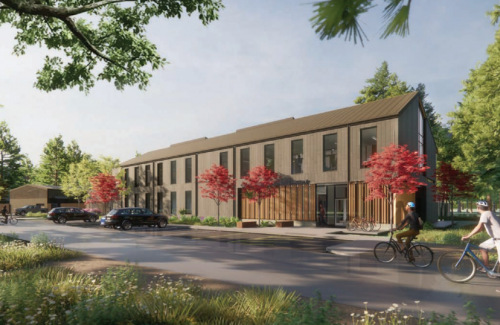 Park Maintenance Facility rendering showing the building in a forested setting with cyclists riding past in the foreground.