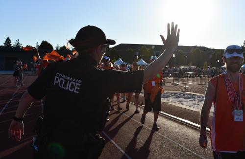 Officer high fiving special olympics athletes