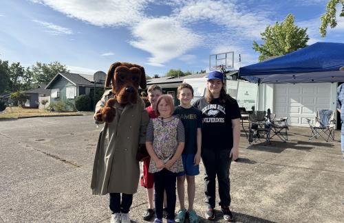 McGruff the crime fighting dog and a group of children outside at national night out
