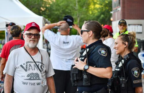 Officers talk to a community member at a public event outside