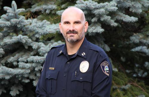 Chief Harvey stands outside in front of a frost covered tree