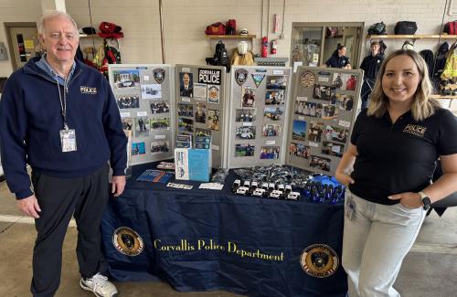 Volunteer and staff in front of a display board at a preparedness fair