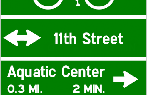 Bicycle Guide Sign Example: Bike Path Left & Right for 11th St; Aquatic Center 0.3 miles Right; Porter Park 0.5 miles Straight