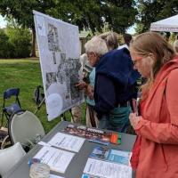 Neighbors join an outdoor ward meeting.