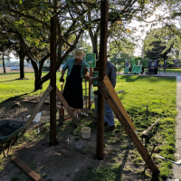 Arnold Park neighbors installing an announcement board in the neighborhood park.