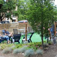 Diners sitting on chairs in a fenced area outside of a pub in downtown Corvallis
