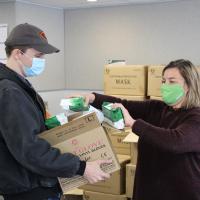 EDO staff handing out free masks and hand sanitizer to local businesses