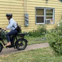 E-bike pedaling past purple flowers