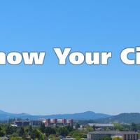 Know your city white text on blue sky background