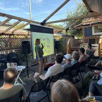 Image of a presentation with an audience. 