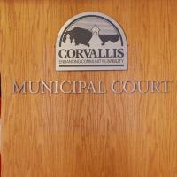 Corvallis Municipal Court logo with American flag and Oregon flag on either side