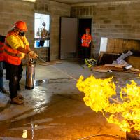 Volunteers dousing a blazing fire with water