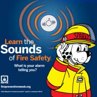 Fire Prevention graphic showing Saprky the fire dog dressed in a yellow jacket listening to a fire alarm