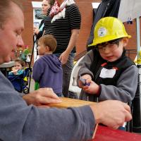 Building inspectors building birdhouses with kids