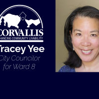 Tracey Yee smiling portrait with white city logo on a blue field