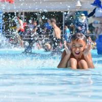girl playing in otter beach outdoor pools