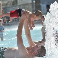 dad and son playing in otter beach pool