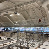 Contractors installing metal shoring supports in the drained pool at Osborn Aquatic Center