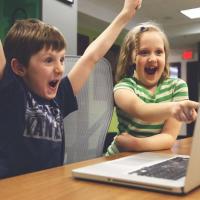 Excited children looking through Parks & Rec classes online