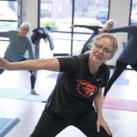 woman in fitness class stretching