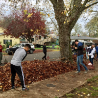 Youth Volunteer Corps members raking leaves