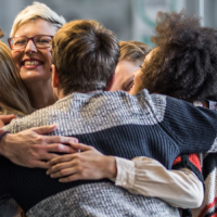 group hug of diverse individuals