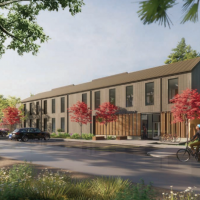 Park Maintenance Facility rendering showing the building in a forested setting with cyclists riding past in the foreground.