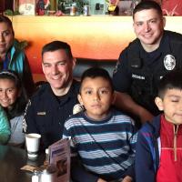 Corvallis police with a group of community members at a restaurant