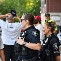 Officers talk to a community member at a public event outside