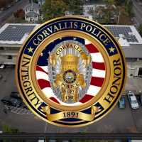 Corvallis Police Logo over aerial view of the Law Enforcement Center in downtown Corvallis