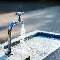 water pouring out of an outdoor spigot
