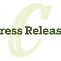 Press release with large green 'C' monogram in the background