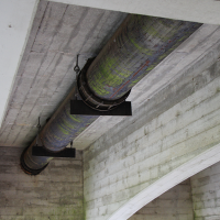 Existing metal water pipe running underneath the 4th Street bridge in Corvallis.