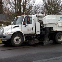 Street sweeper parked on the side of the road