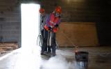 Participants practice extinguishing a trashcan fire.