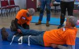 Instructors demonstrate proper splinting technique during training.