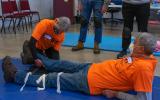 Instructors demonstrate proper splinting technique during training.